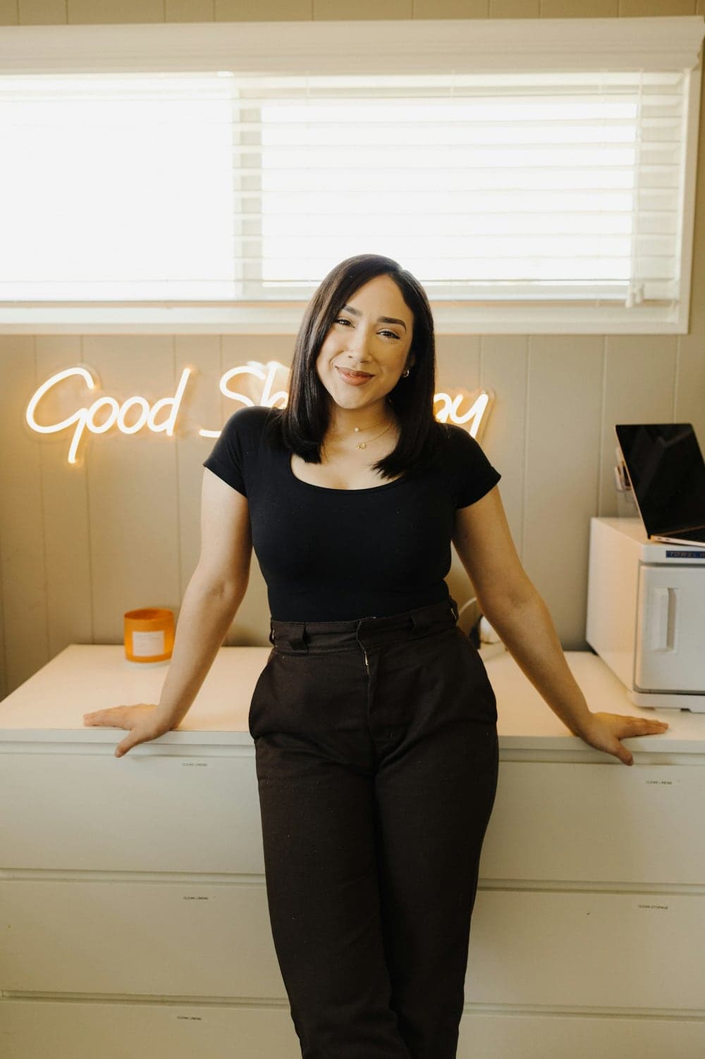 A small-business owner standing behind her counter