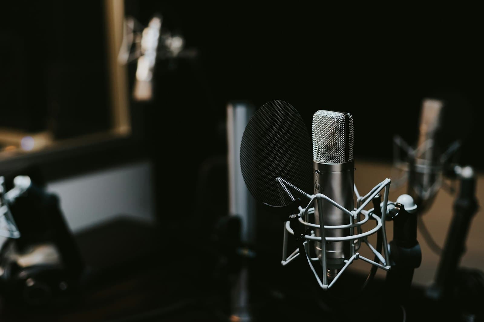A studio microphone with pop filter in a recording studio